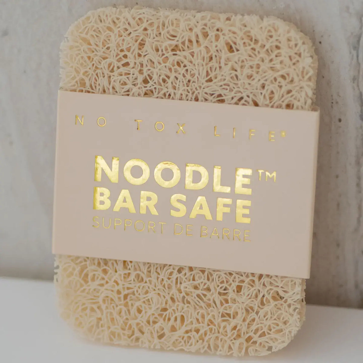 Noodle bar safe product with 'No Tox Life' label on a neutral background