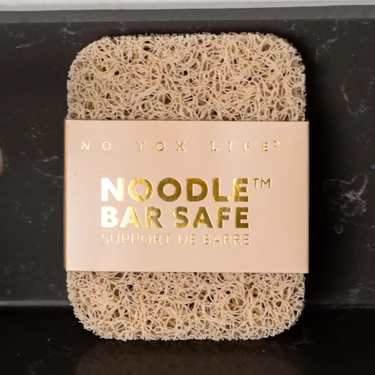 Noodle bar safe product with 'No Tox Life' label on a dark background