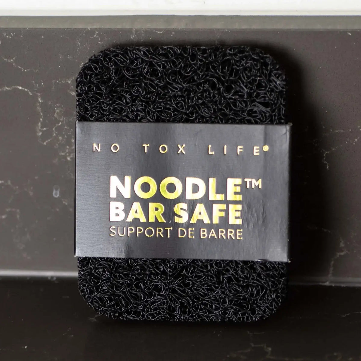 Black noodle bar with 'No Tox Life' label on a dark background
