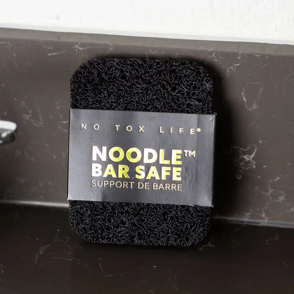 Black foam noodle bar safety support with 'No Tox Life' label on a gray background