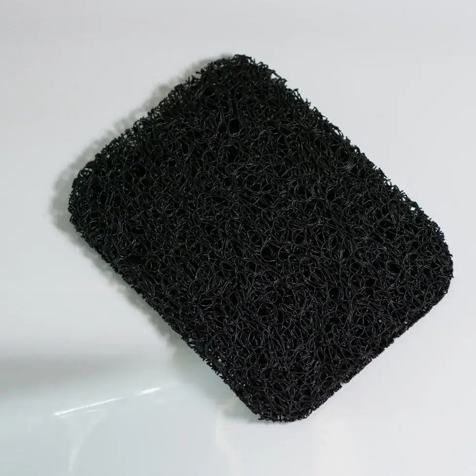Black scrubber on a white surface