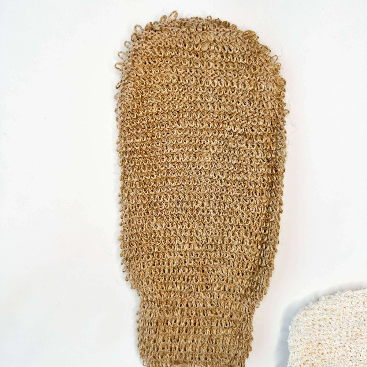 Brown loofah glove on a white background