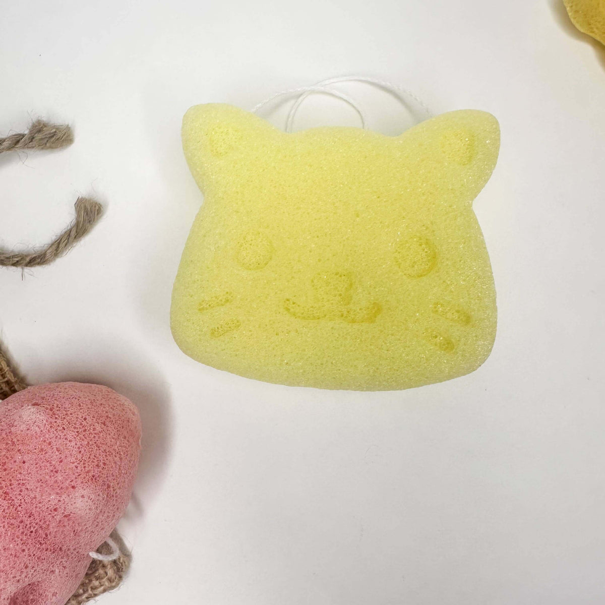 Natural Organic Konjac Facial Sponges in a cute cat shape, perfect for gentle exfoliation and skincare.