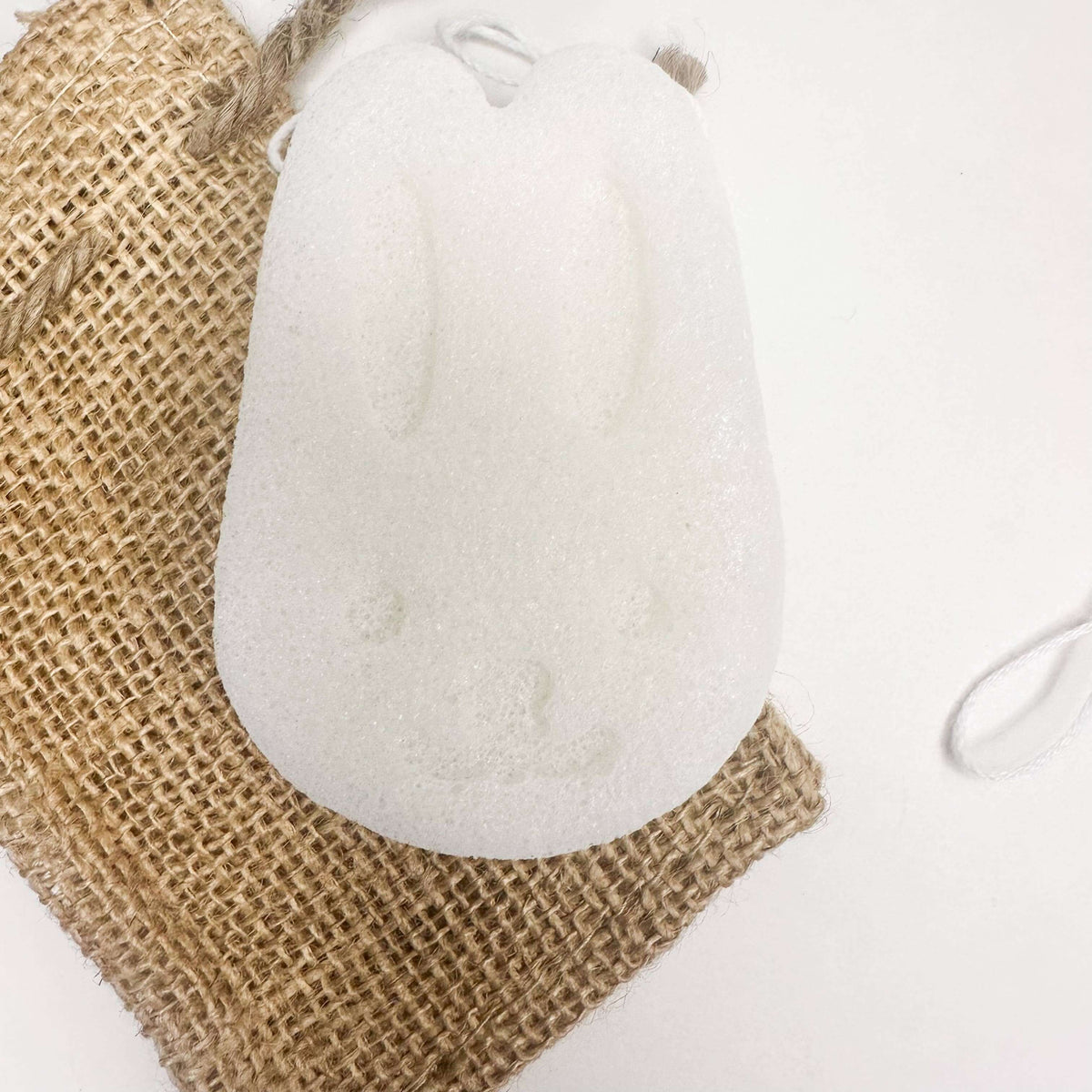 Natural Organic Konjac Facial Sponges - cute bunny shape on burlap background.
