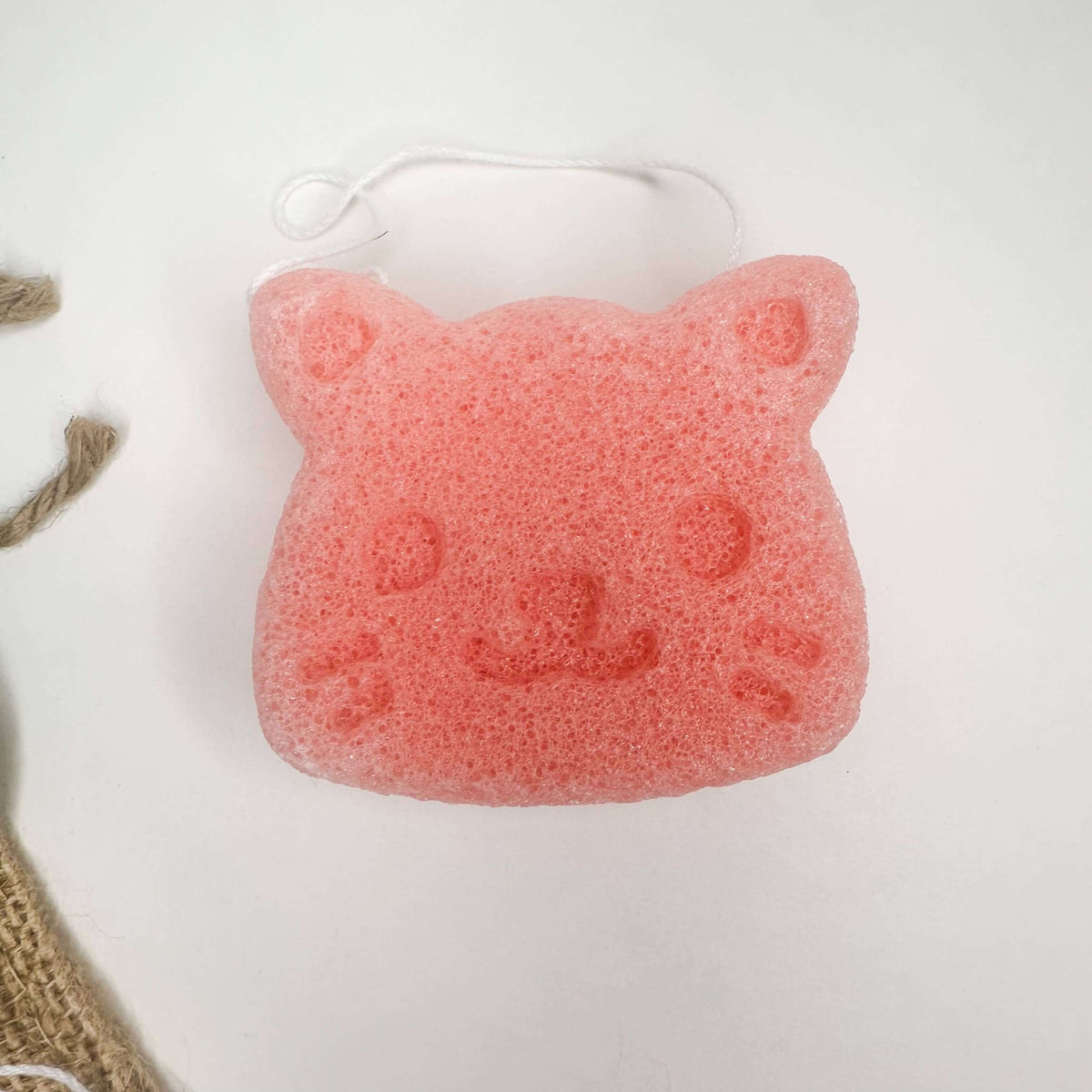 Cute pink konjac facial sponge shaped like a cat, perfect for gentle skincare with Natural Organic Konjac Facial Sponges.
