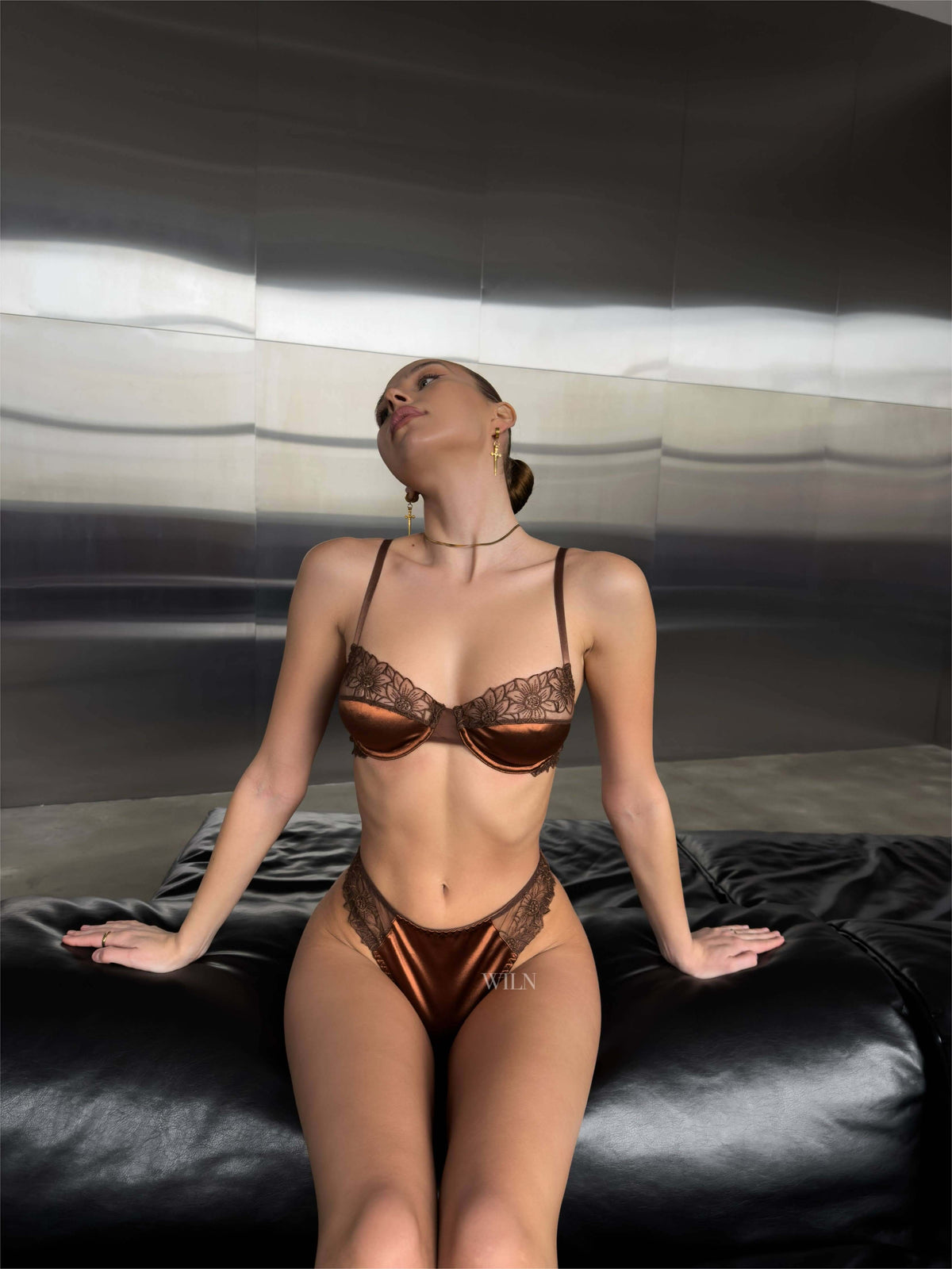 PROMISCUOUS Bronze - 2 Piece Lingerie Set displayed on a model in a modern setting, highlighting the elegant satin and lace design.