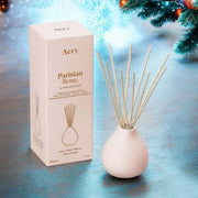 Parisian Rose Reed Diffuser in a stylish white vase with reed sticks, perfect for adding glamour to any space.