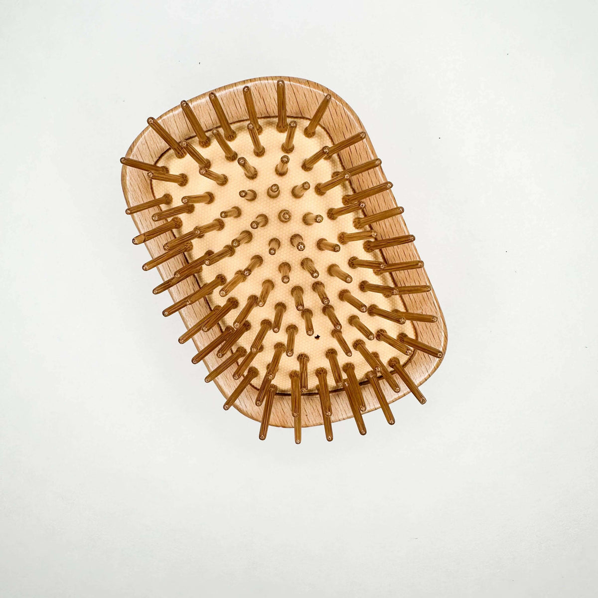 Wooden hairbrush with bristles on a white background