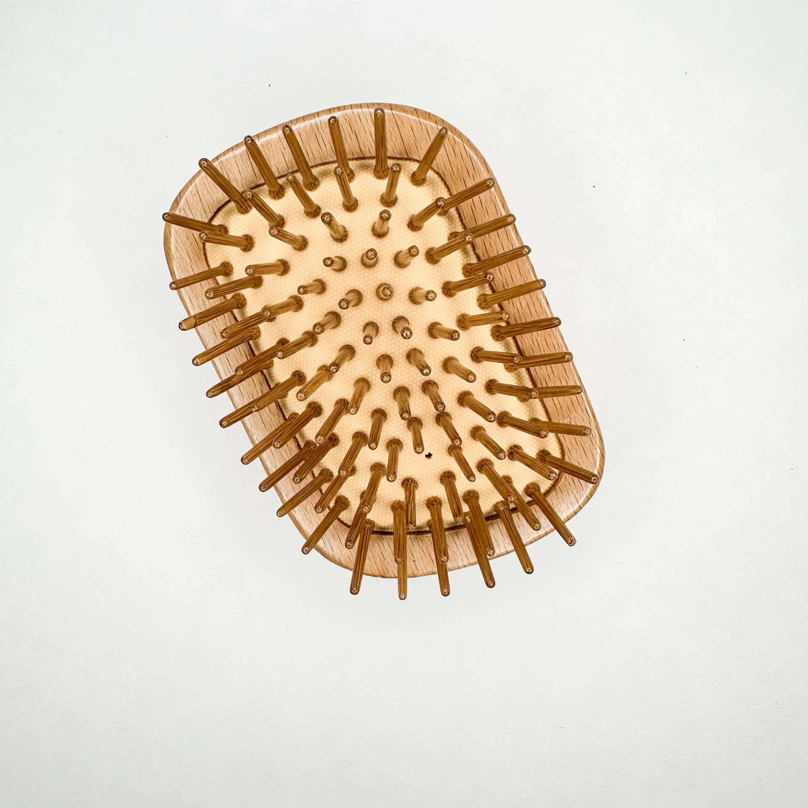Wooden hairbrush with bristles on a white background