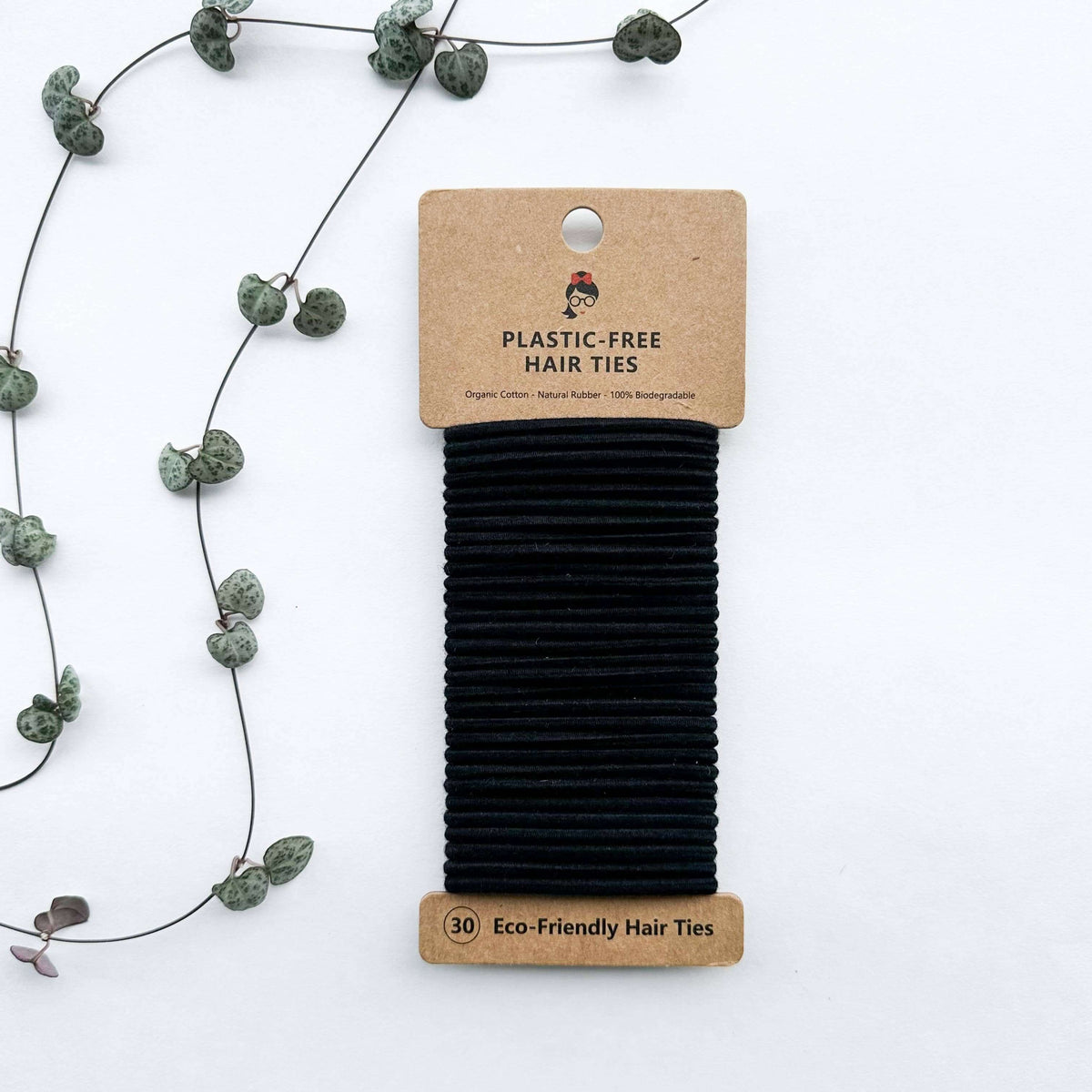 Pack of black eco-friendly hair ties with a cardboard packaging on a white background