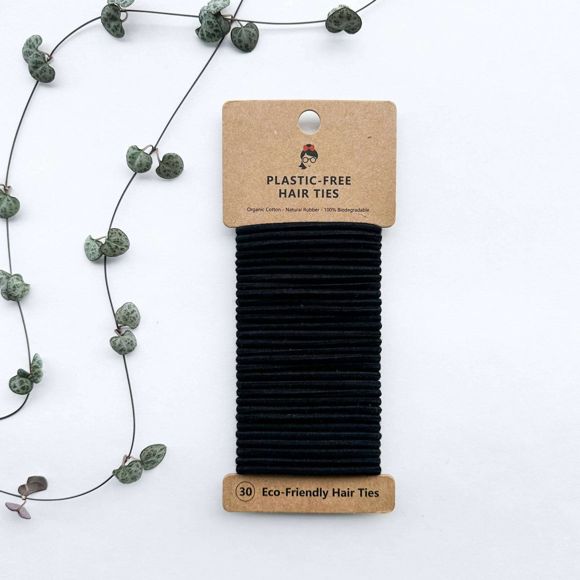 Pack of black eco-friendly hair ties with a cardboard packaging on a white background