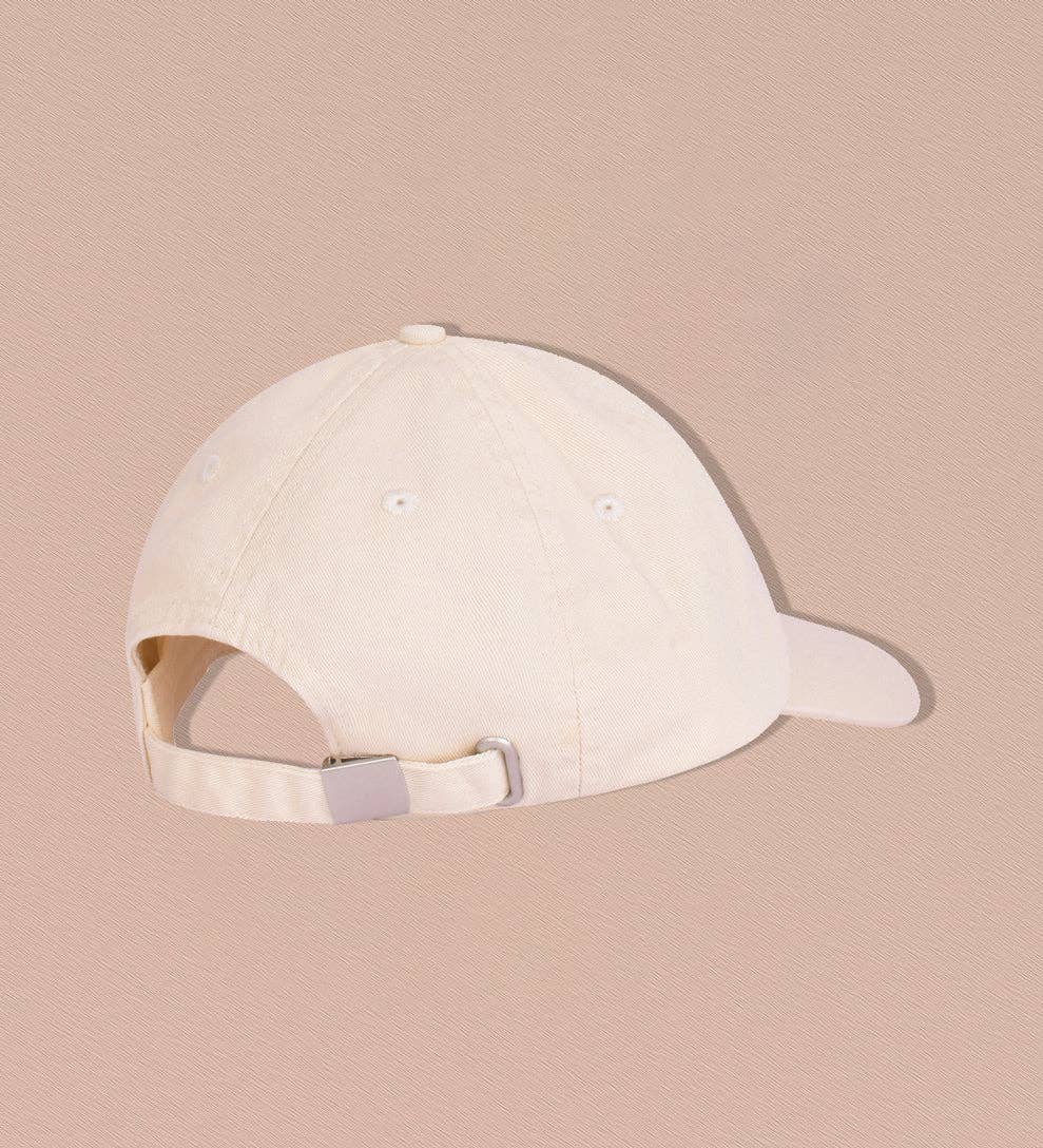 Back view of a pre-washed canvas cap in oat shade showcasing adjustable metal clasp and breathable design.