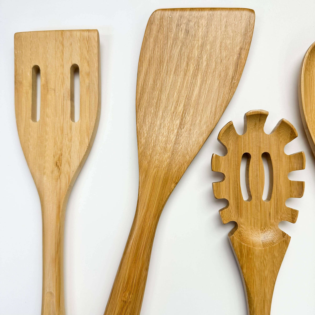 Set of wooden kitchen utensils on a white background