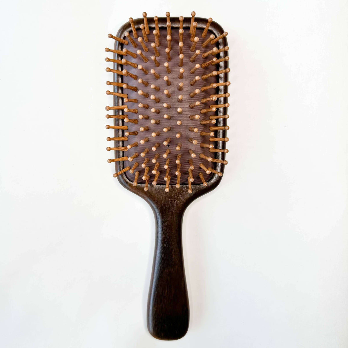 Wooden hairbrush on a white background
