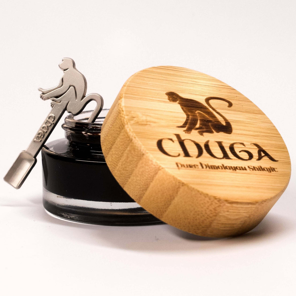 Pure Himalayan Shilajit resin in a jar with a bamboo lid featuring a monkey design.