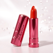 Red lipstick with a shiny pink case on a white background