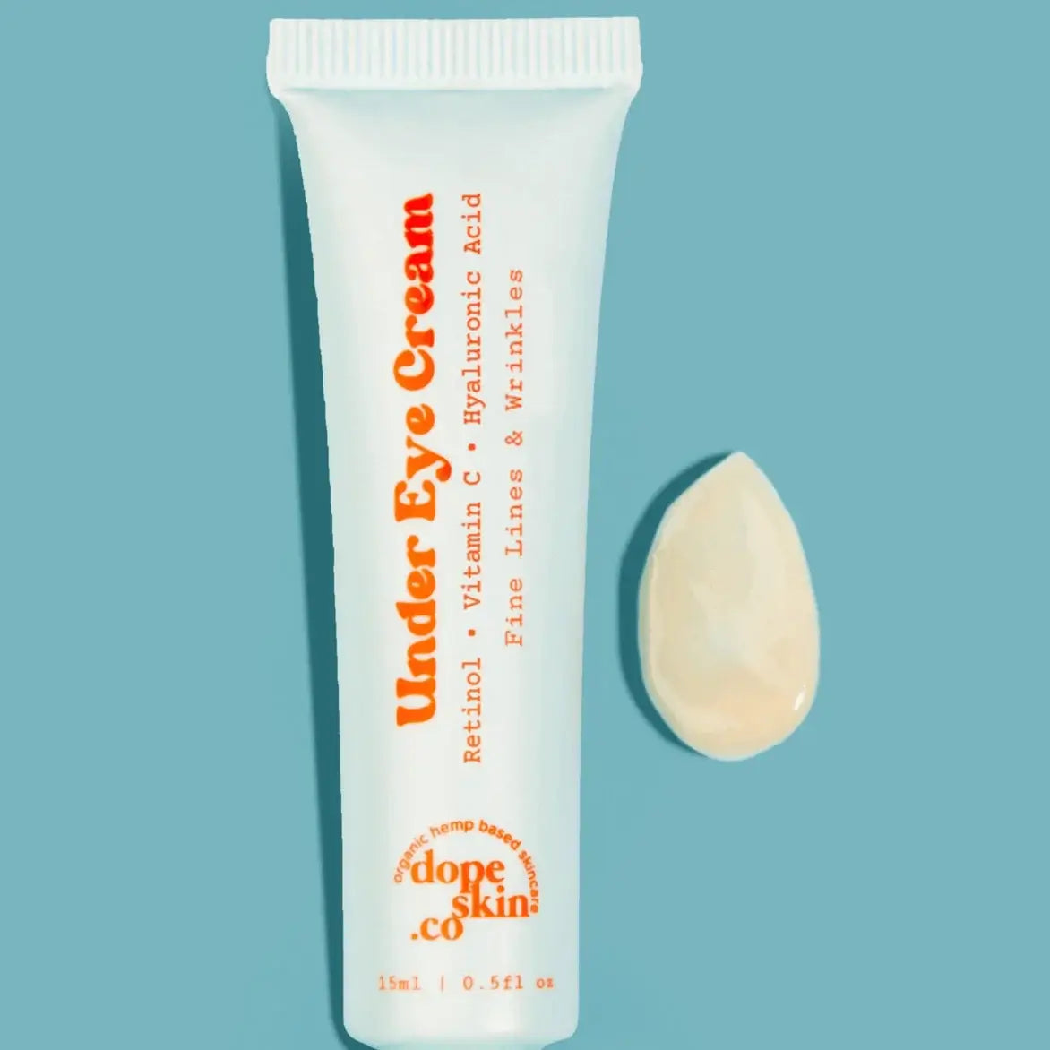 Under Eye Cream tube with a droplet on a light blue background