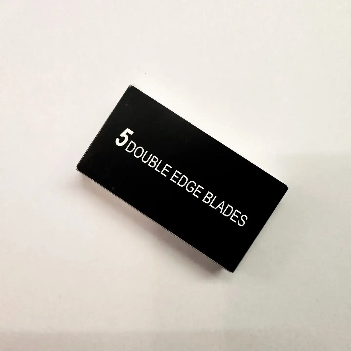 Black box with '5 Double Edge Blades' text on a light beige background