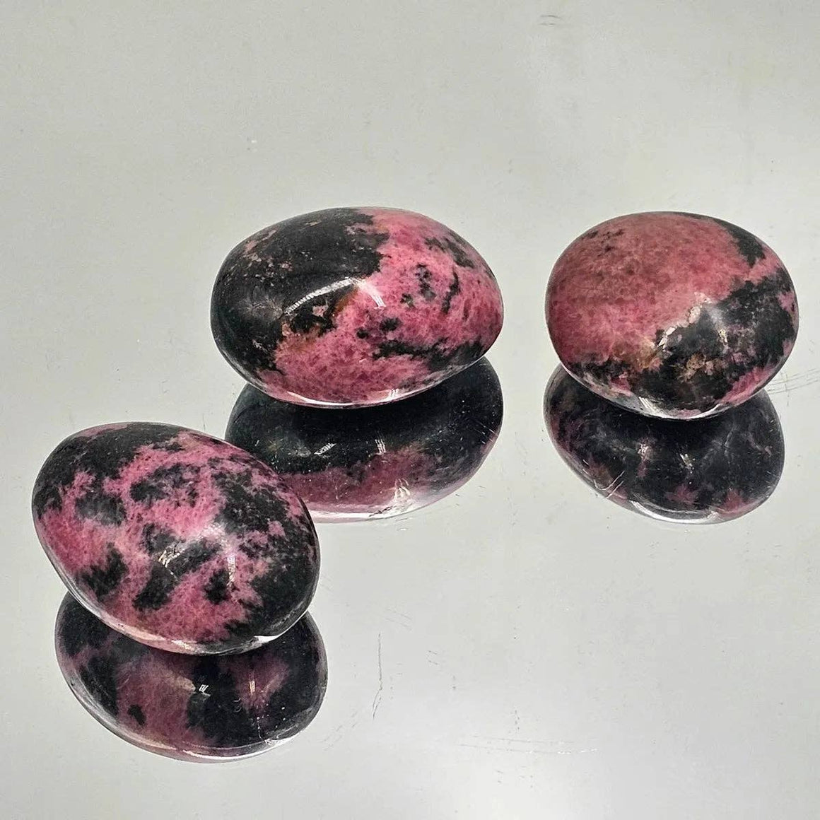 Rhodonite Crystal Palm stones, hand carved and polished, perfect for meditation and energy work.