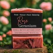 Rose Geranium Bar Soap - Soap Boutique displayed in a floral setting, showcasing its artisan craftsmanship and natural ingredients.