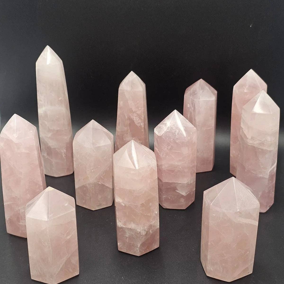 Rose Quartz Crystal Towers arranged artistically showcasing their natural color and clarity, perfect for meditation and energy work.