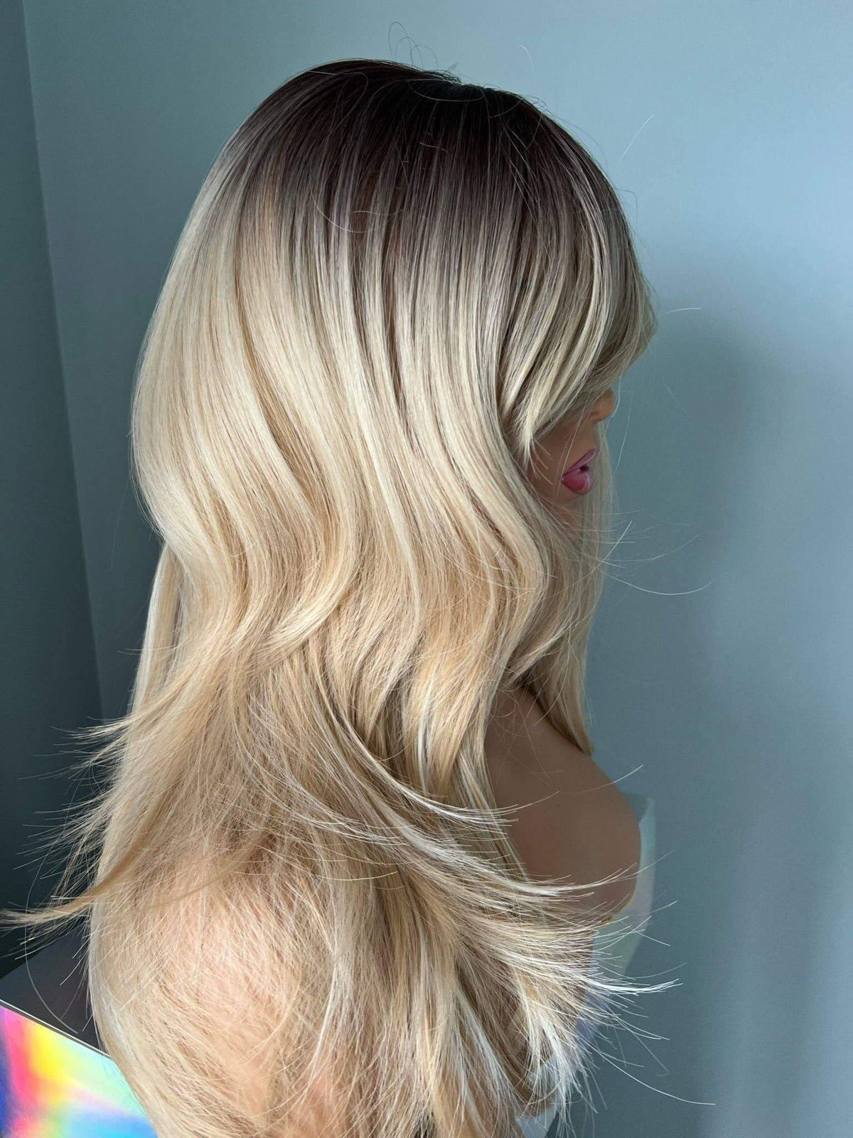 Rylee Mixed Blonde Wig with Layers and Bangs showcasing soft, natural layers and feathered bangs, displaying a glamorous look.
