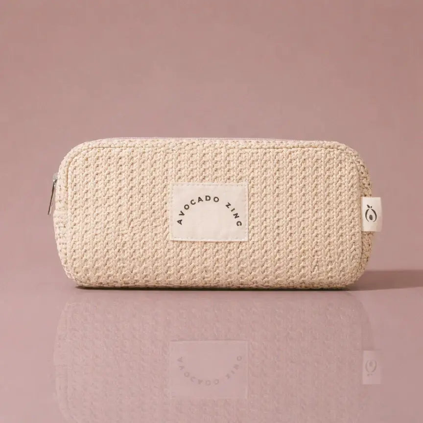 Sand Straw Pouch-Avocado Zinc in sandy beige with high-quality zip closure on a pink background.