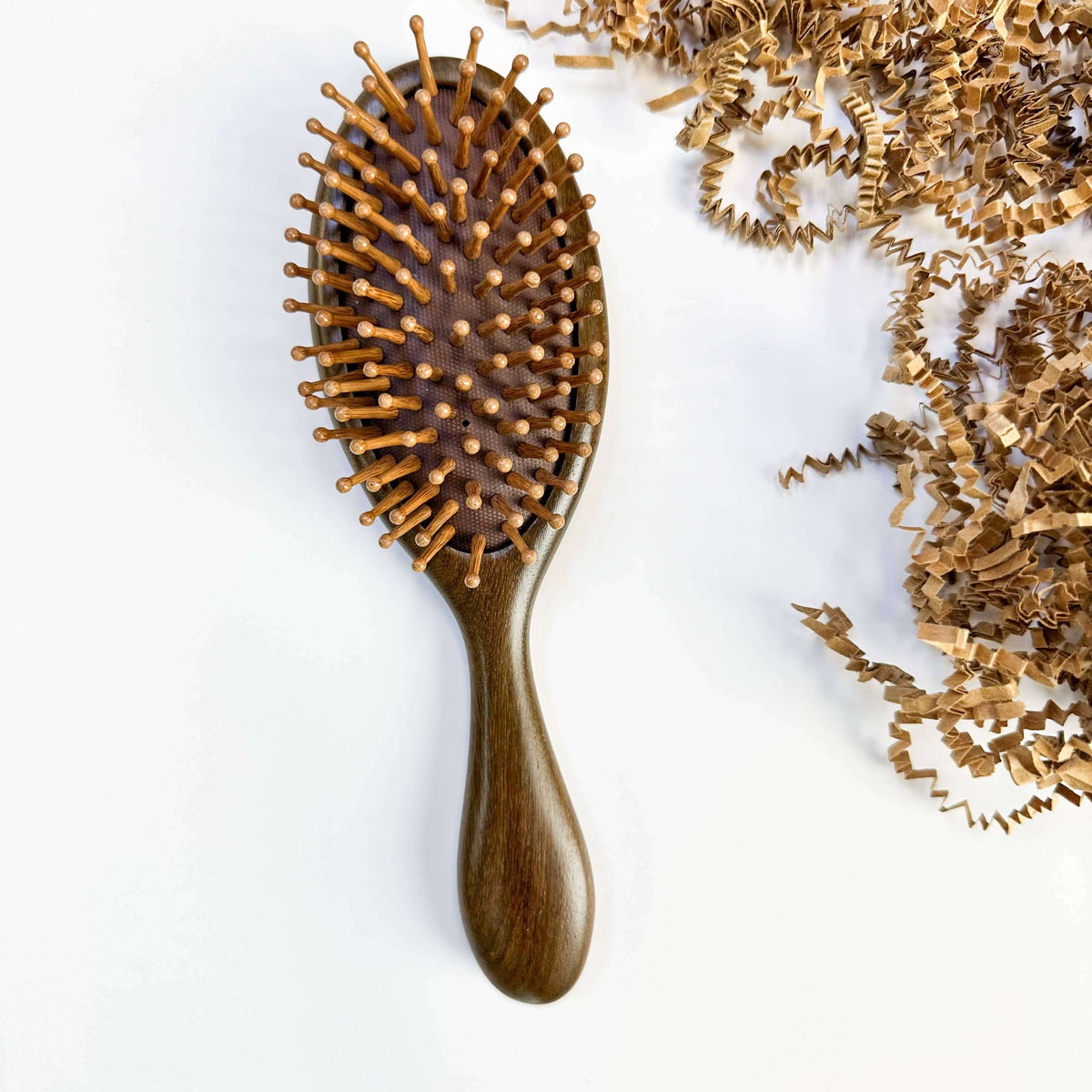 Wooden hairbrush with bristles on a white background