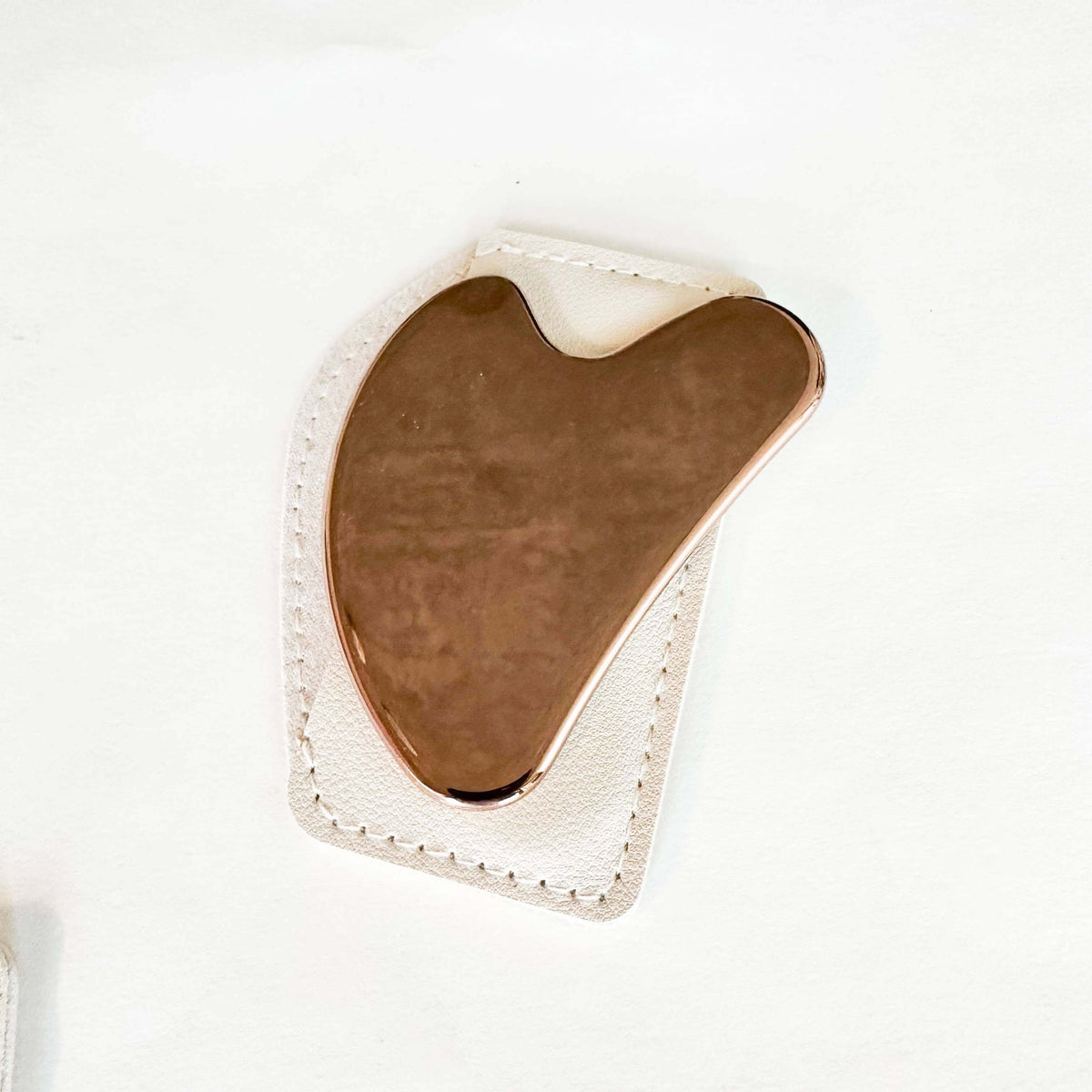 Gua Sha tool on a white background