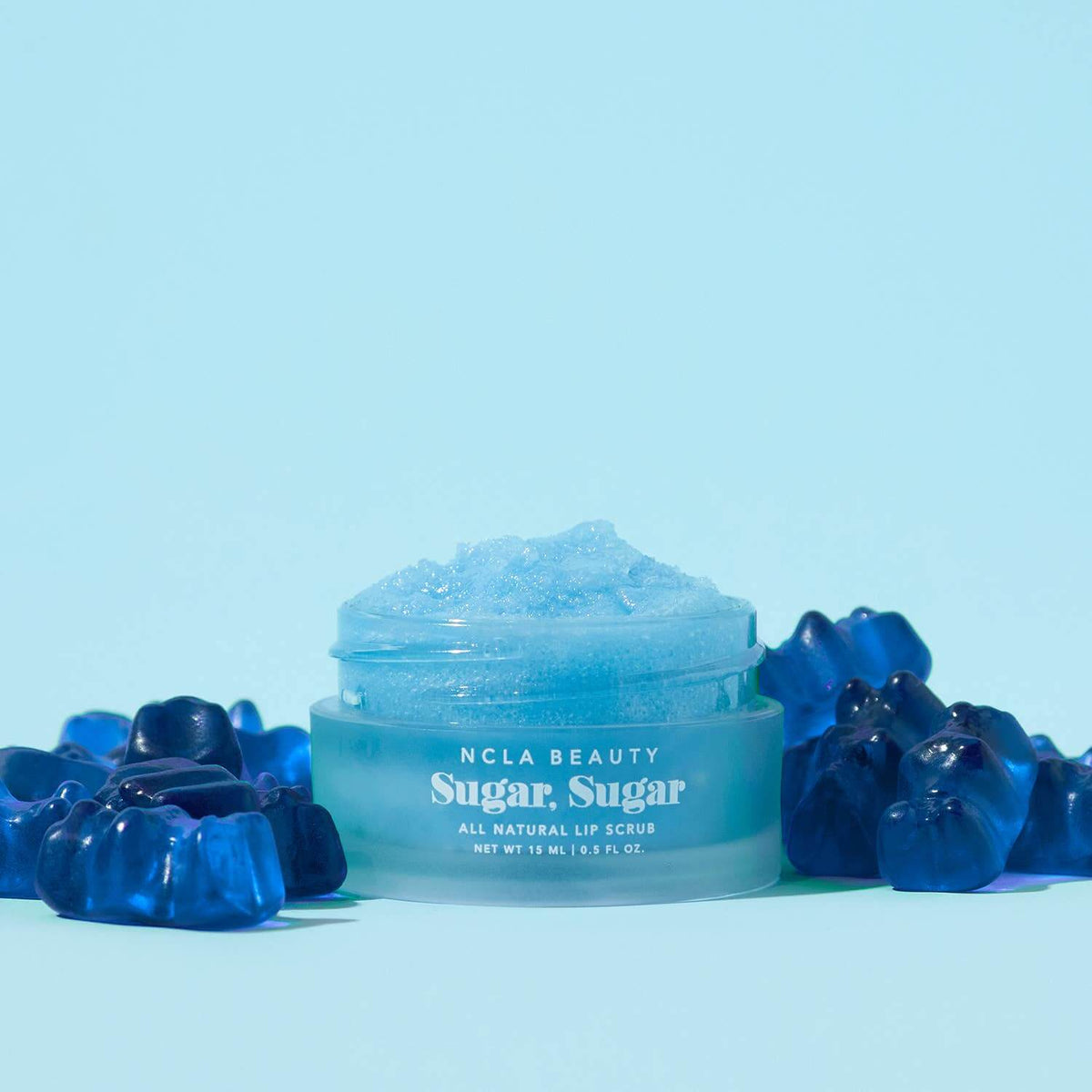 NCLA Beauty Sugar, Sugar lip scrub with blue packaging on a light blue background