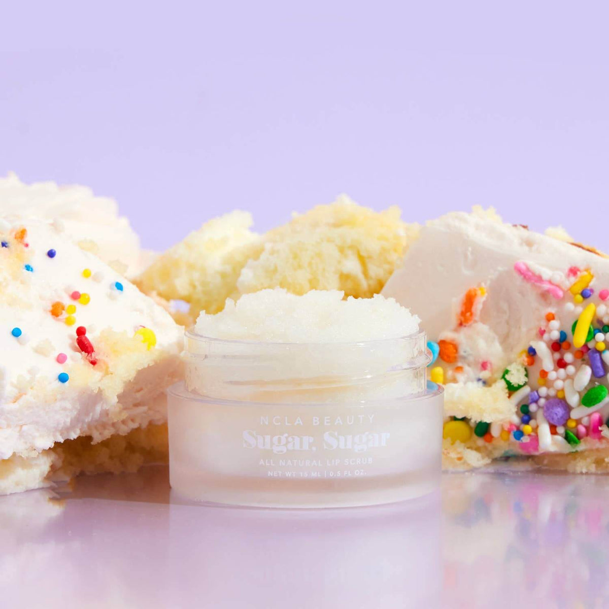 Bowl of cake batter with a small container labeled 'Sugar Sweet' on a light purple background