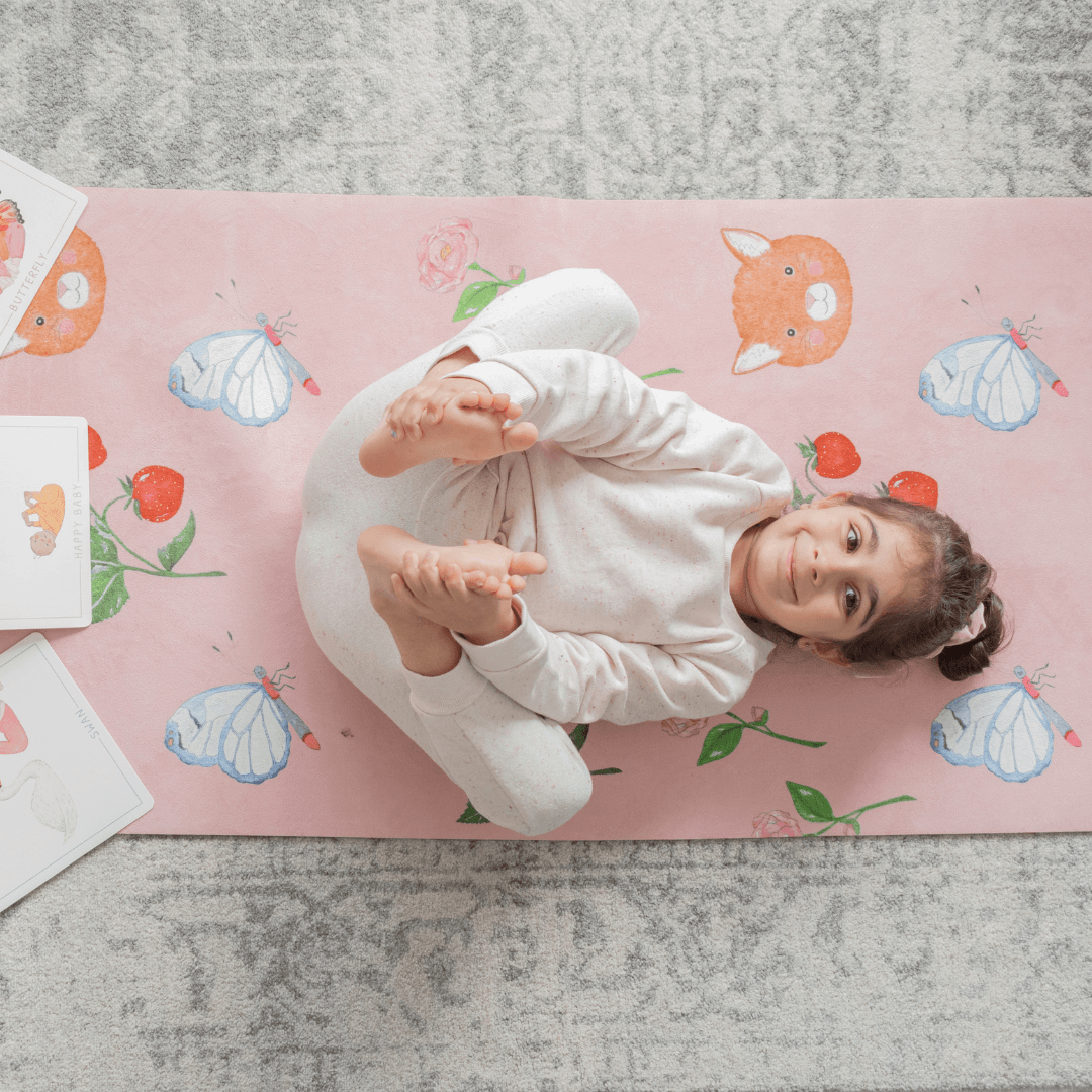 Sweet Print Kids Yoga Mat featuring a child practicing yoga on a colorful mat with animal and butterfly designs.