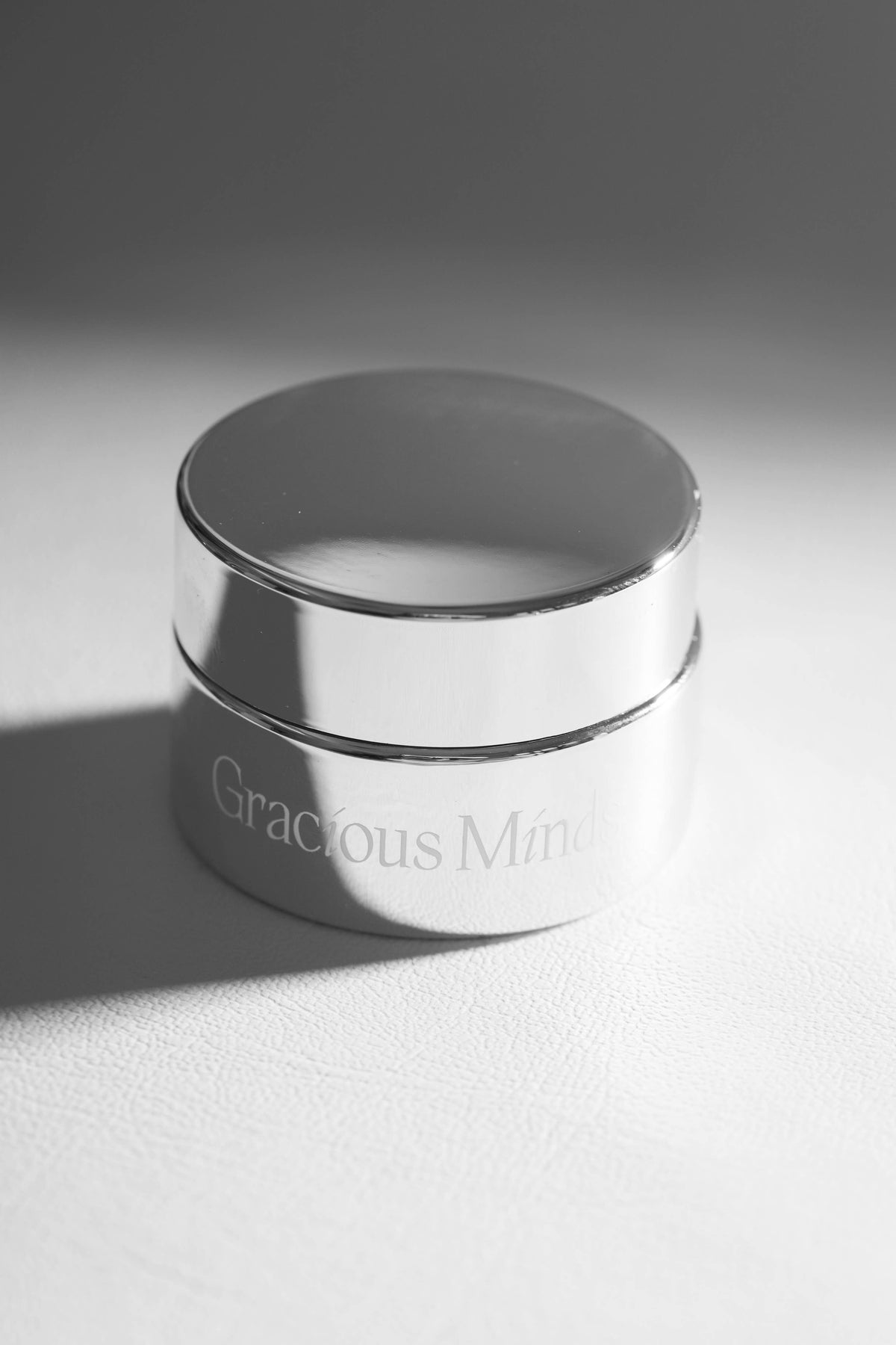 AM PM radiance skincare set in a sleek silver jar on a soft surface, showcasing luxurious skincare for all day glow.