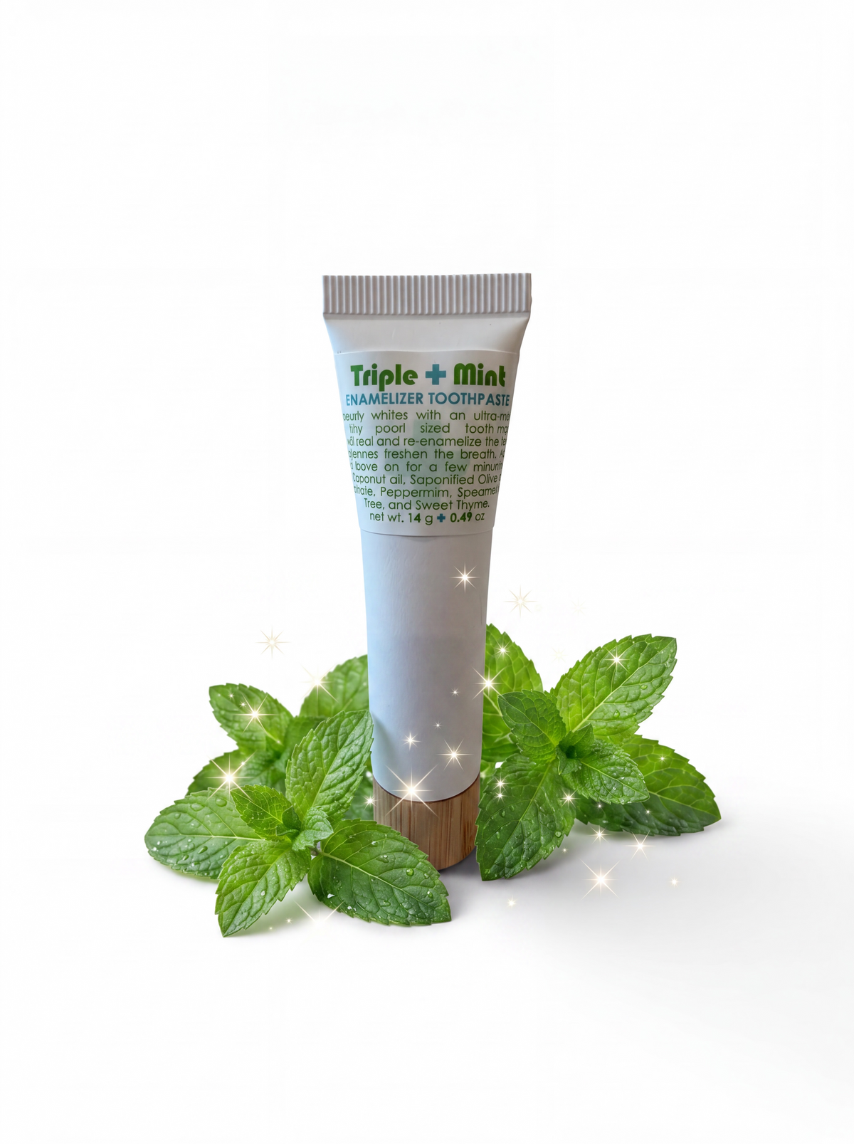 A tube of Triple Mint Unwhitzer Toothpaste stands upright on a white background, surrounded by fresh green mint leaves and small sparkles. The tube is white with green text and a brown cap.