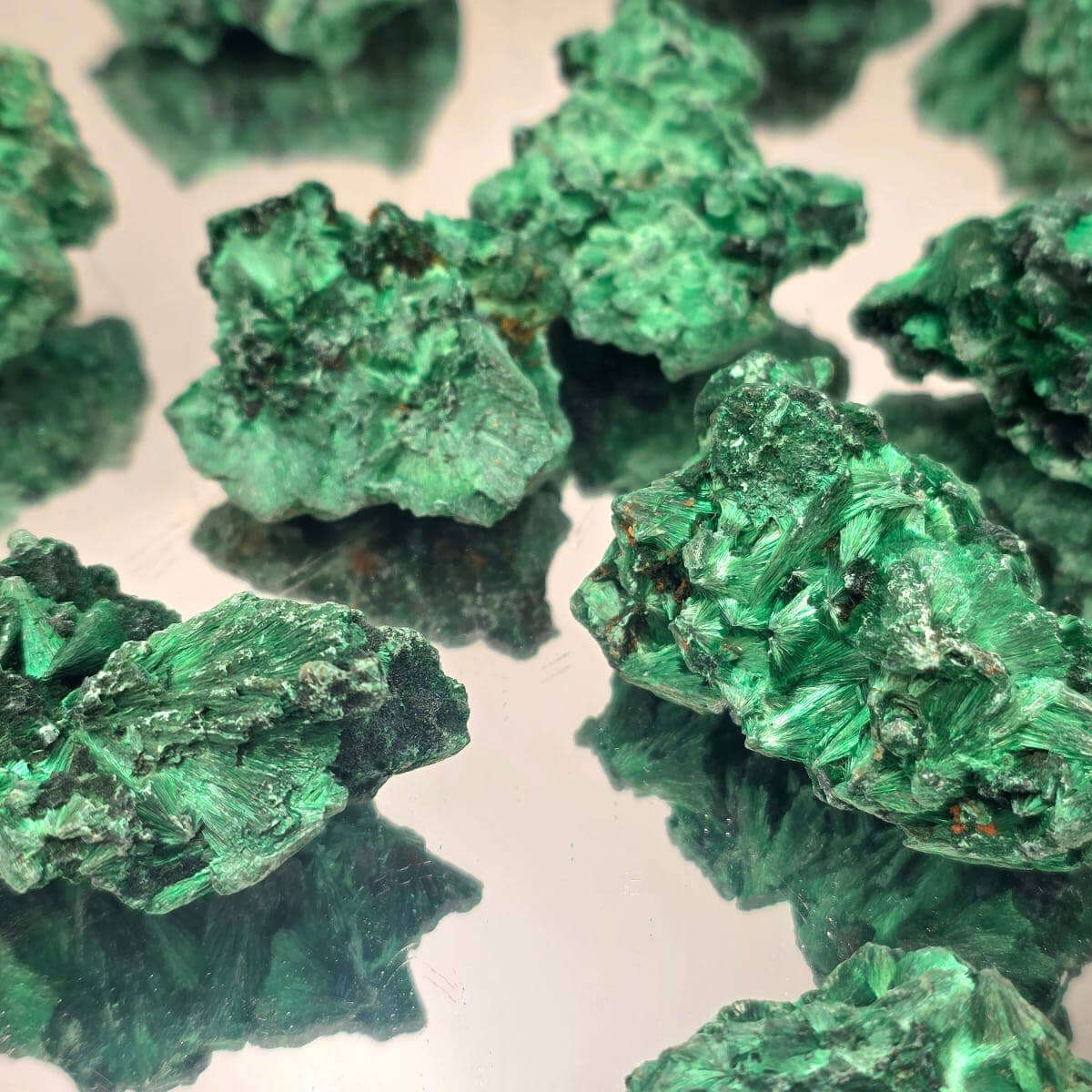 Velvet Malachite Crystals Natural 200g with deep emerald-green color and velvety texture on reflective surface.