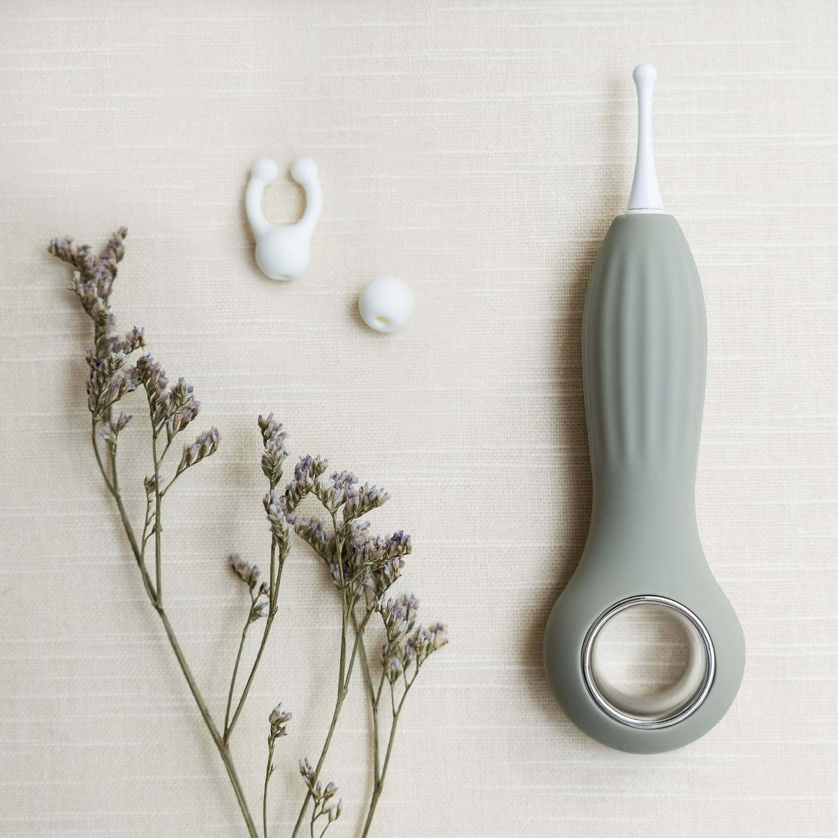 Samphire Precision Vibrator with interchangeable heads, ergonomic design, and premium silicone, styled with gentle florals.