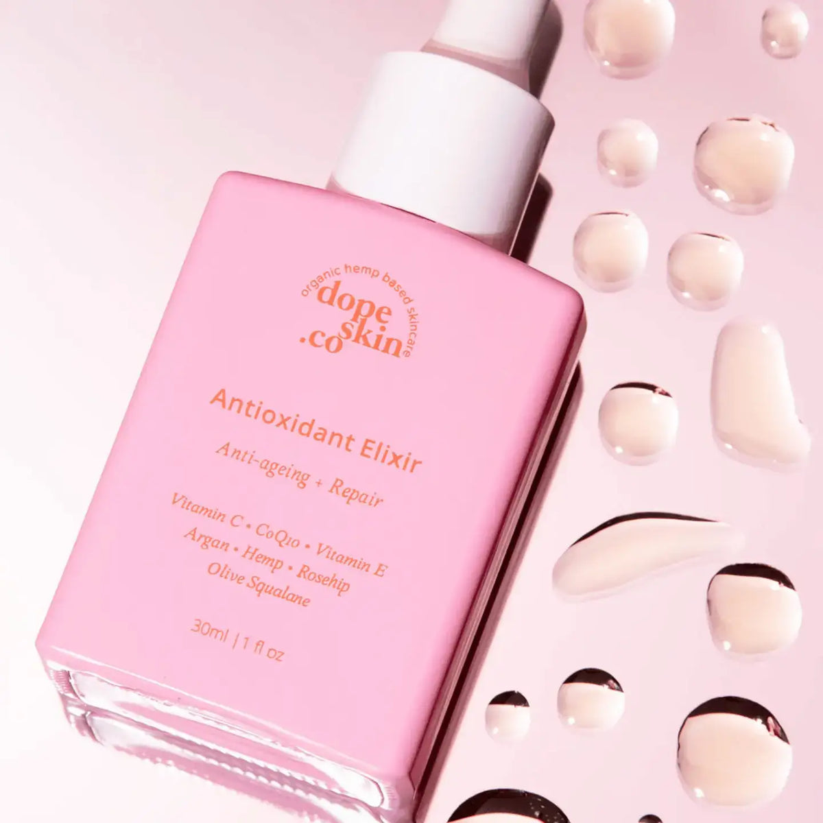 Pink bottle of 'dope skin co.' Antioxidant Elixir with decorative elements on a pink background