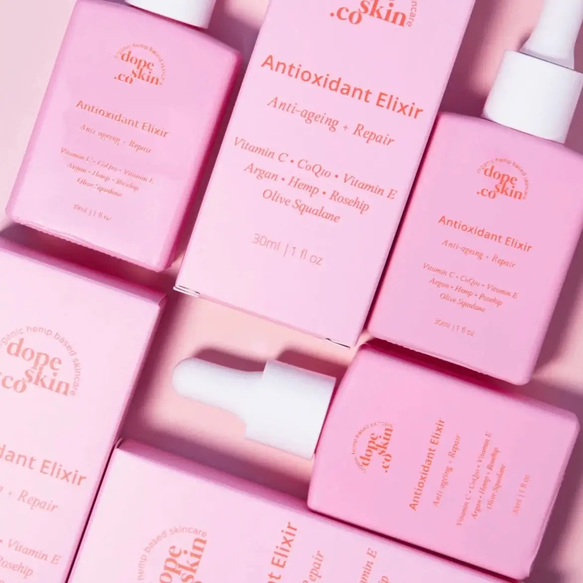 Pink bottles of 'dope skin co' Antioxidant Elixir on a pink background