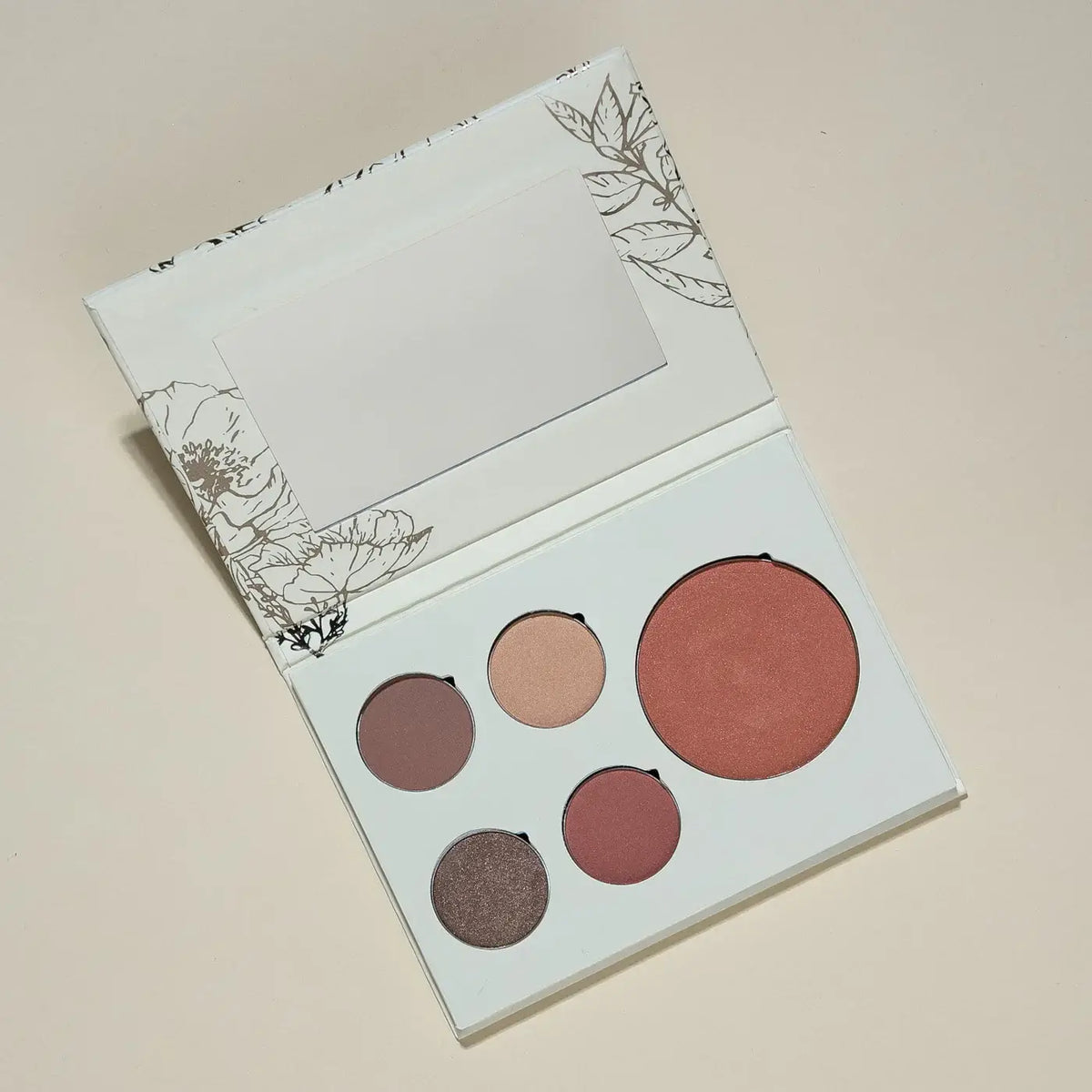 Makeup Seasonal palette with four shades on a beige background