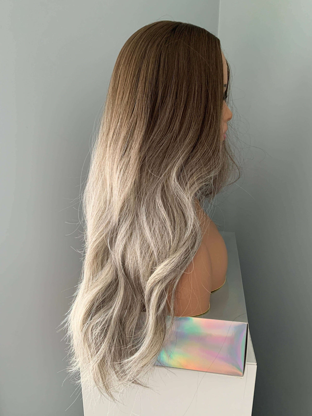 Side view of the Willow Long Wavy Grey Silver Wig, featuring loose waves and an ash brown base with silver highlights.