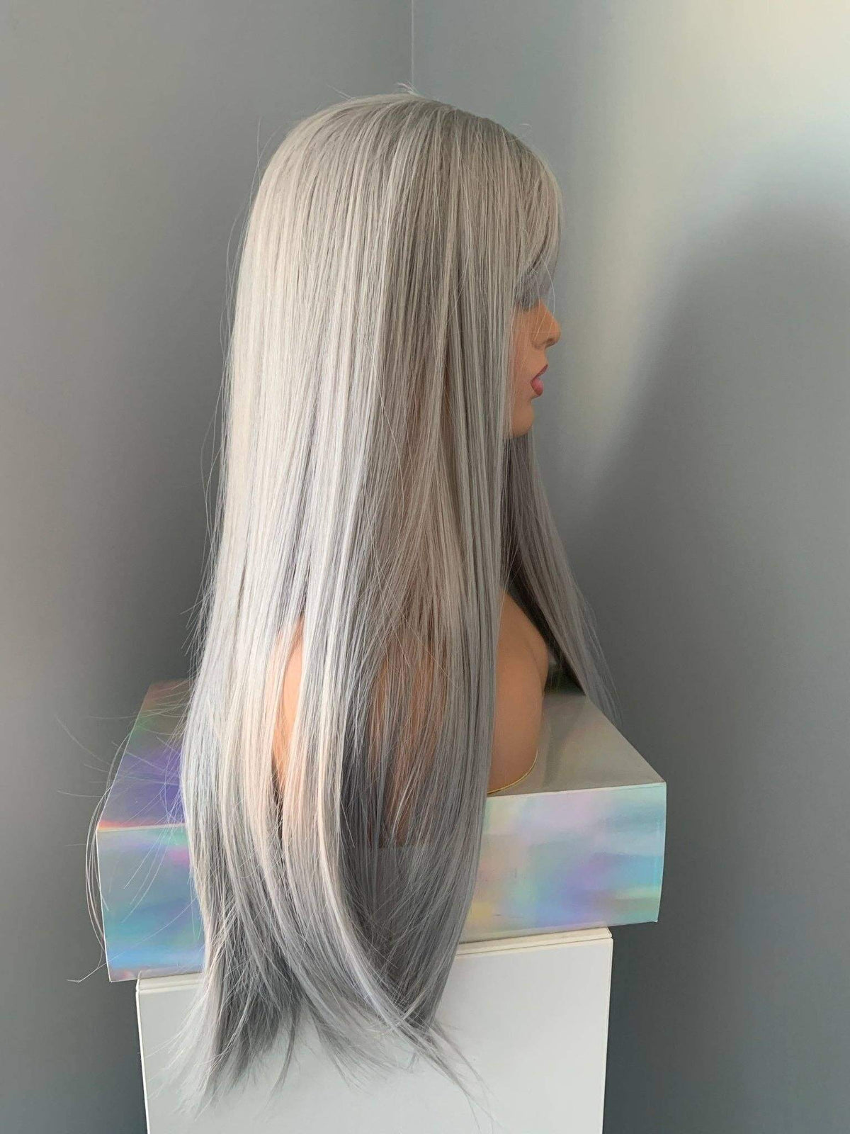 Winny Long Straight Grey Silver Wig with Bangs displayed from the side, showcasing silky straight strands and full bangs.