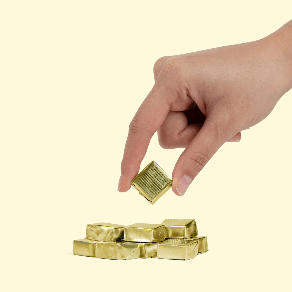 Hand reaching for WonderBee mushroom honey chews, highlighting the convenient packaging of the delicious wellness supplement.
