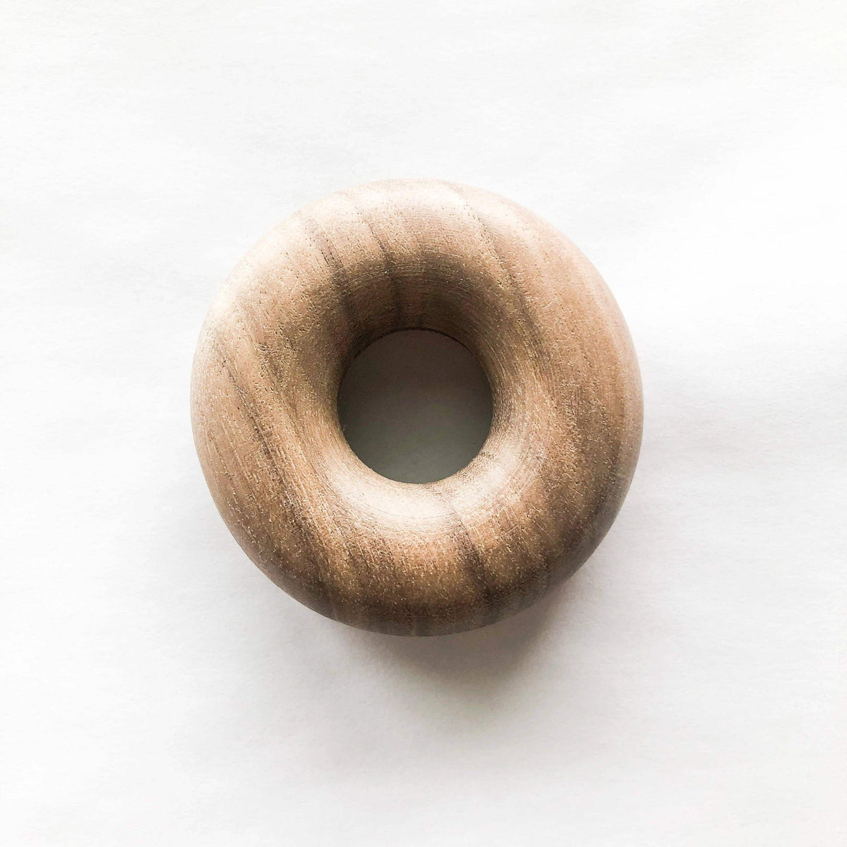 Wooden donut-shaped object on a white background