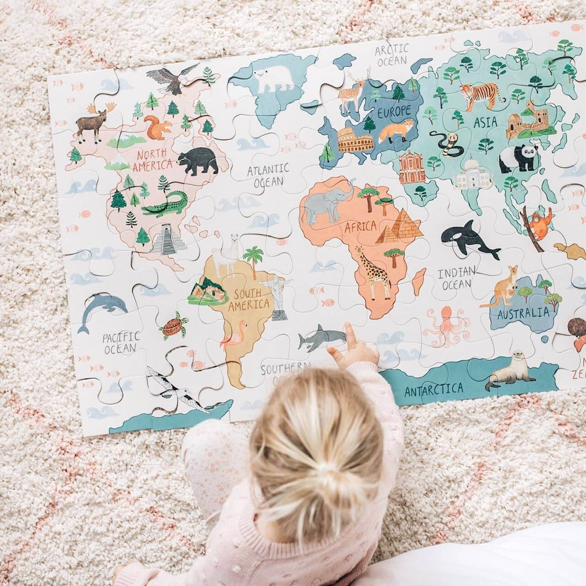 Child exploring the World Map Floor Puzzle, an engaging educational toy fostering creativity and mindfulness.
