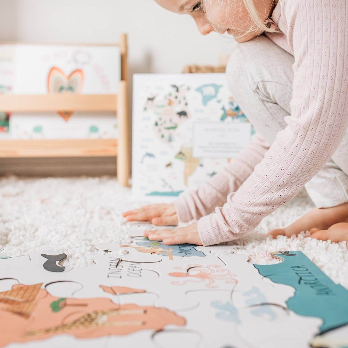 Child engaged with the World Map Floor Puzzle on a soft carpet, promoting creativity and learning.
