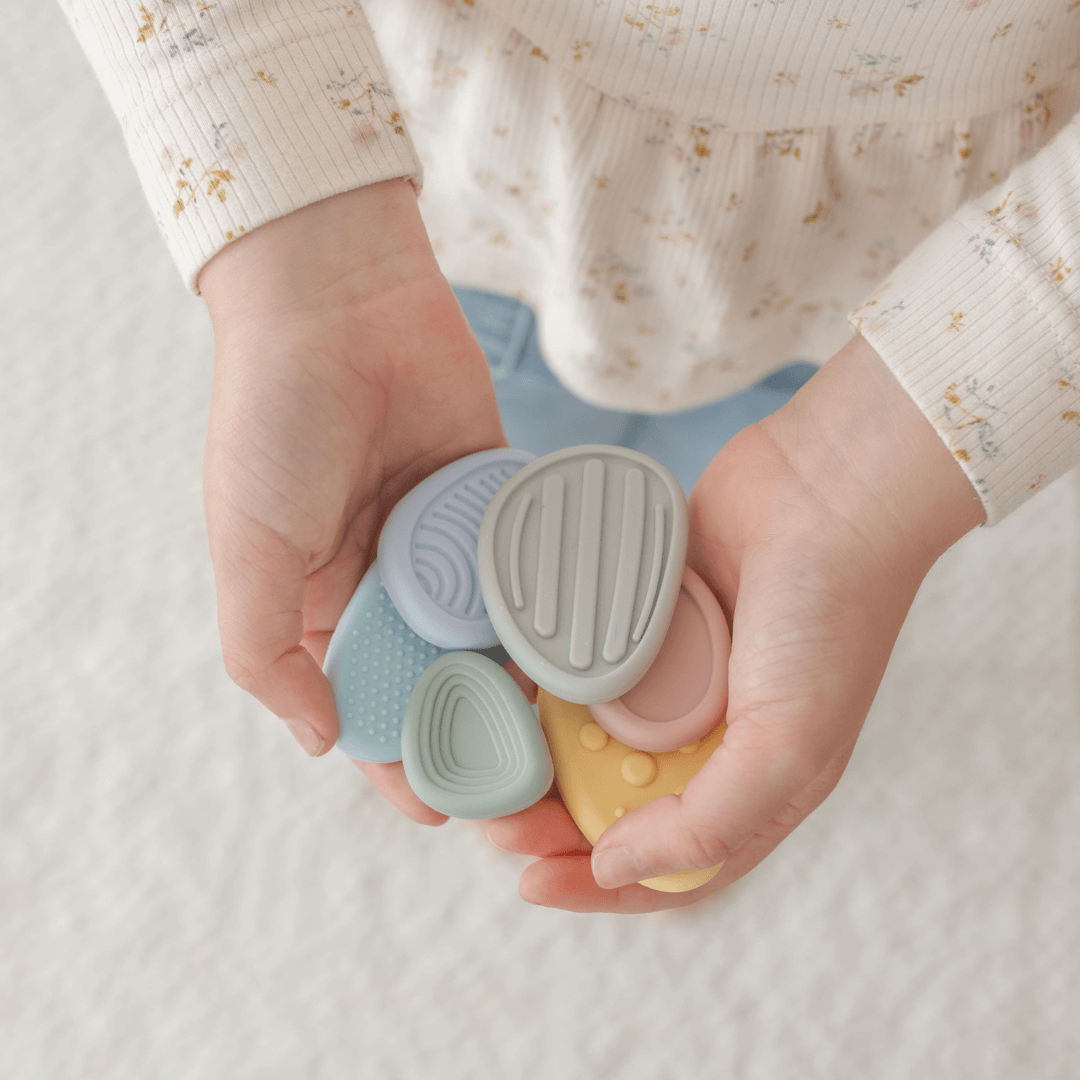 Worry Stones – Calming Sensory Fidget for Kids (Set of 6) held by a child, showcasing their soft pastel colors and tactile design.
