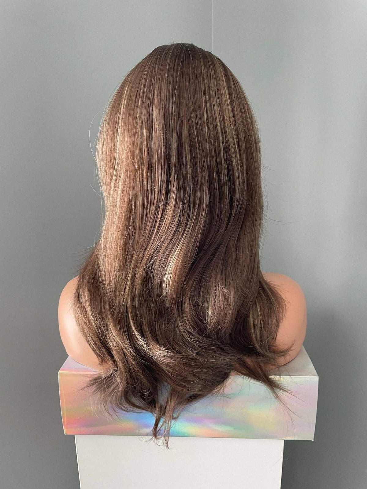 Yaz Brown Layered Wig with Blonde Highlights showcasing a natural flow and dimension from the back view.
