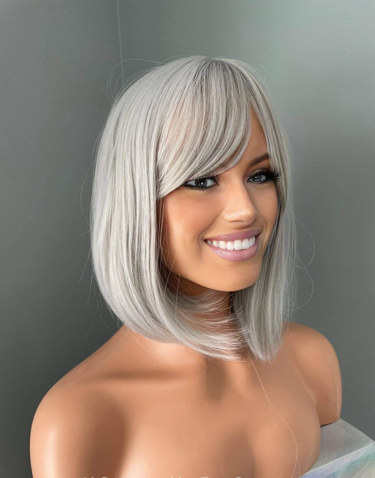 Yvette Short Silver Bob Wig showcasing a chic silver bob hairstyle with soft side-swept bangs, perfect for elegance.