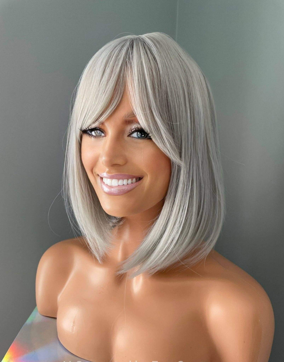 Yvette Short Silver Bob Wig showcasing a chic rounded bob with side-swept bangs in stunning ash silver color.