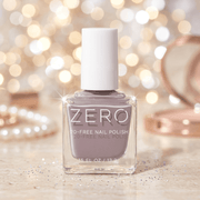 Bottle of ZERO nail polish with a blurred festive background
